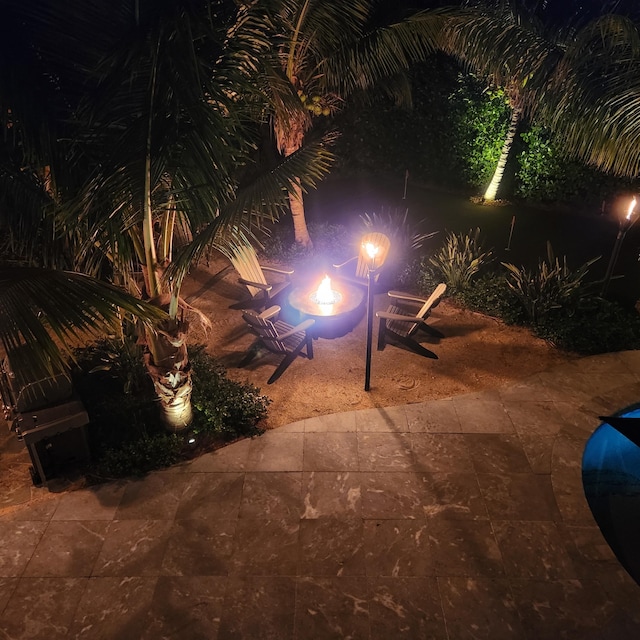 view of yard featuring an outdoor fire pit and a patio area