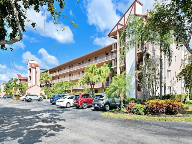 view of building exterior with uncovered parking