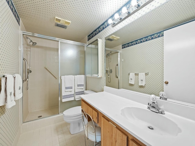bathroom featuring a stall shower, wallpapered walls, toilet, and tile patterned flooring