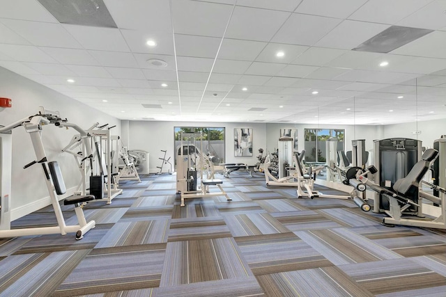 exercise room with baseboards, recessed lighting, and carpet