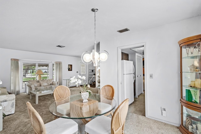 carpeted dining space with an inviting chandelier and visible vents