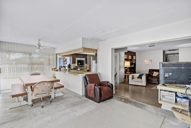 interior space with concrete floors and a ceiling fan