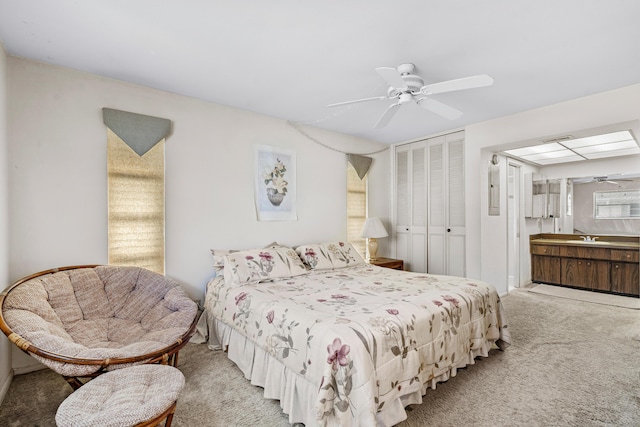 bedroom with ceiling fan, connected bathroom, visible vents, a closet, and carpet