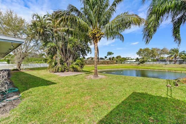 view of yard featuring a water view and fence