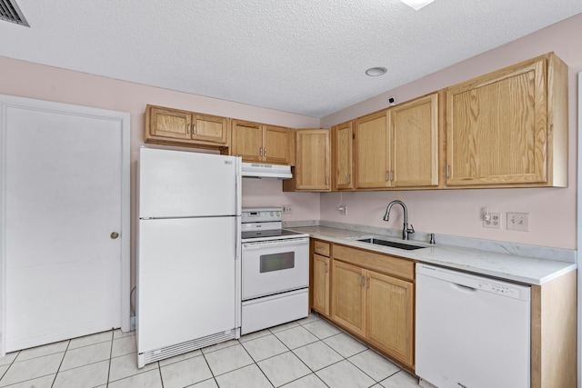 kitchen featuring light countertops, light tile patterned flooring, a sink, white appliances, and under cabinet range hood