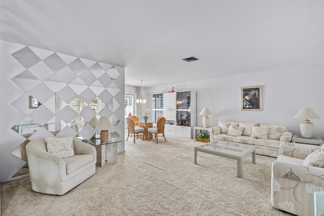 carpeted living area featuring a chandelier, visible vents, and a textured ceiling