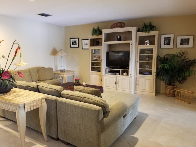 living area with light tile patterned flooring and visible vents