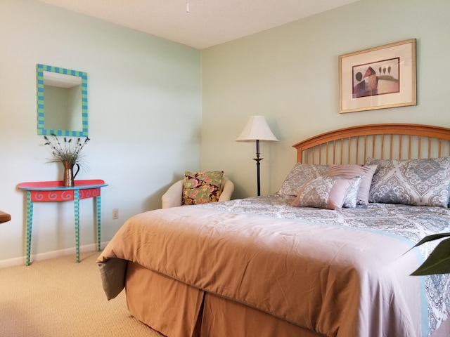 bedroom featuring carpet floors and baseboards