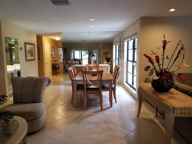 dining room with recessed lighting, a healthy amount of sunlight, visible vents, and light tile patterned flooring