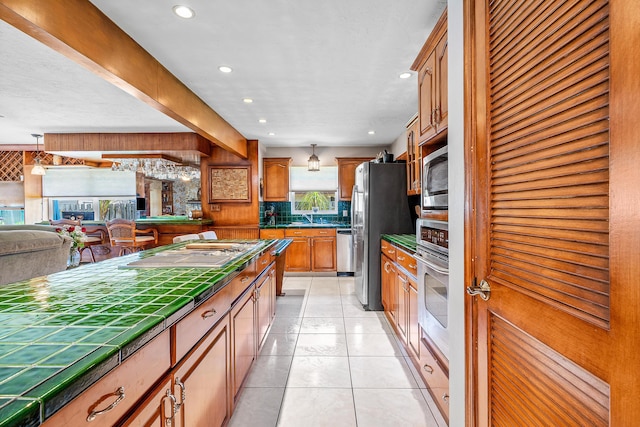 kitchen featuring light tile patterned floors, stainless steel appliances, recessed lighting, and decorative backsplash