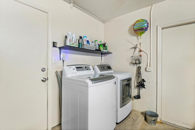 clothes washing area featuring separate washer and dryer and laundry area