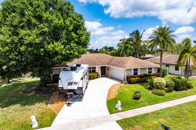 ranch-style house featuring concrete driveway, a front lawn, stucco siding, and an attached garage