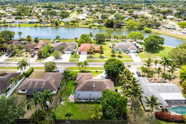 drone / aerial view with a water view and a residential view