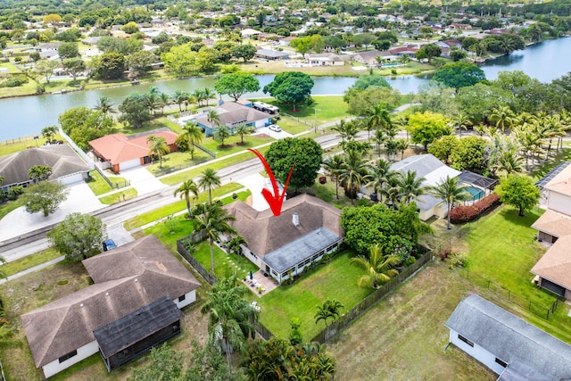 bird's eye view featuring a water view and a residential view