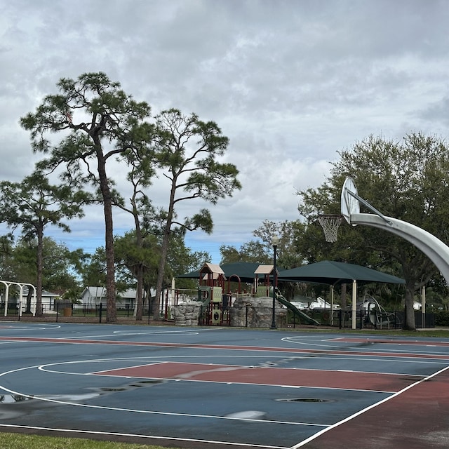 view of basketball court with community basketball court, playground community, and fence