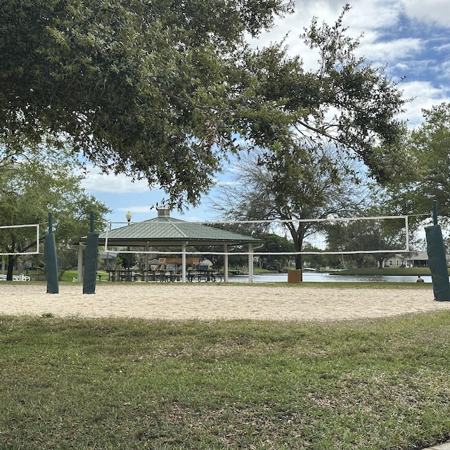 view of community with a gazebo, volleyball court, and a lawn