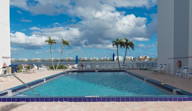 community pool featuring a view of city and a patio