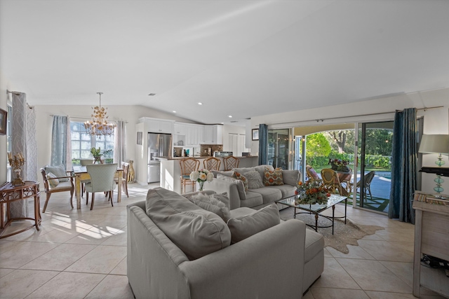 living room featuring lofted ceiling, an inviting chandelier, and light tile patterned flooring