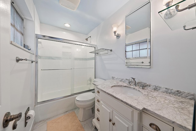 full bath with toilet, visible vents, bath / shower combo with glass door, and vanity