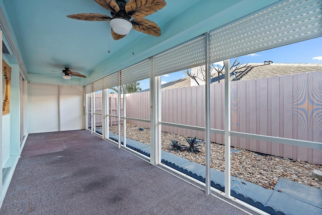 unfurnished sunroom featuring ceiling fan
