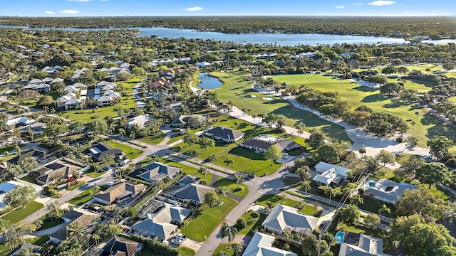 drone / aerial view with golf course view, a water view, and a residential view