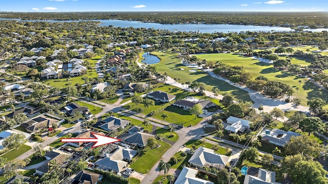 bird's eye view with golf course view, a water view, and a residential view