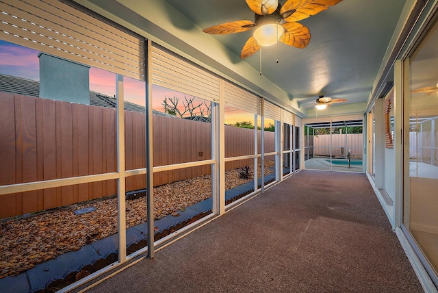 interior space featuring ceiling fan and a fenced backyard