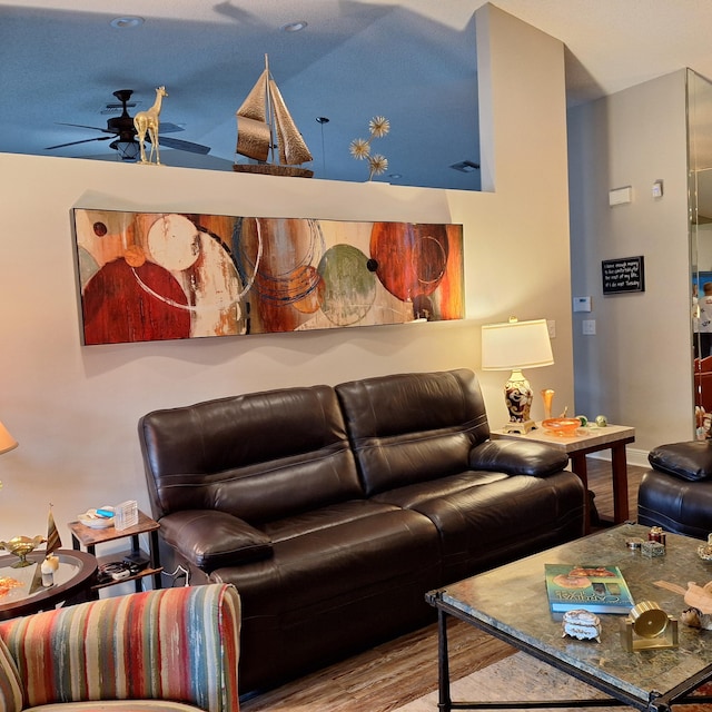 living area featuring ceiling fan and wood finished floors