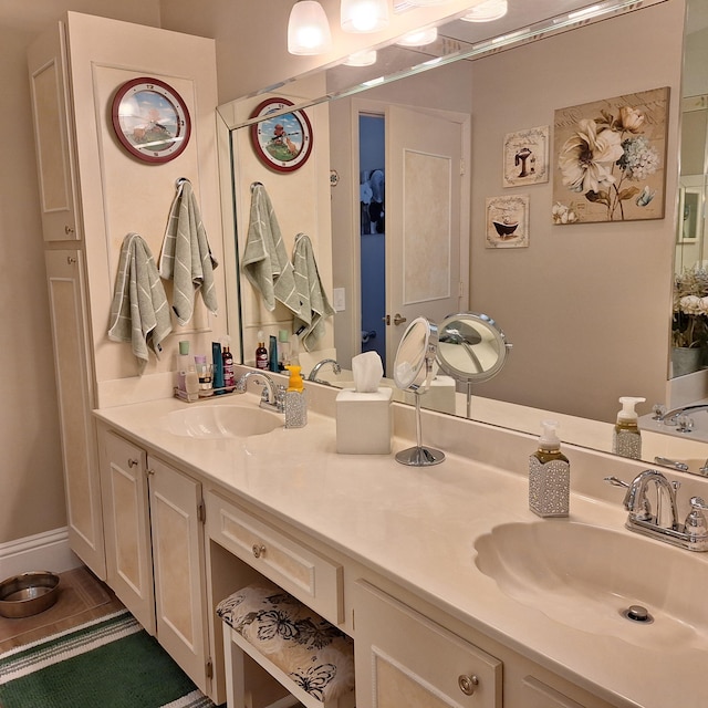 bathroom featuring tile patterned floors, a sink, and double vanity