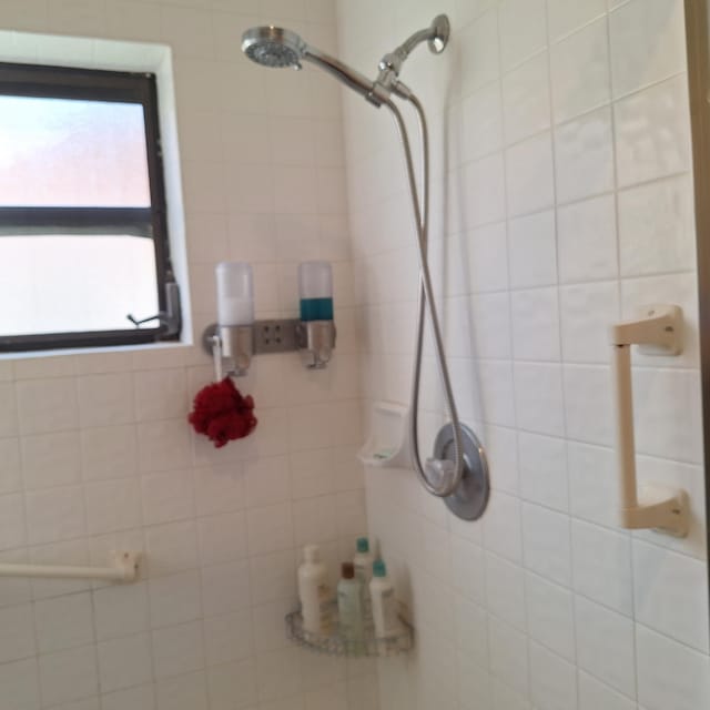 full bathroom with tiled shower