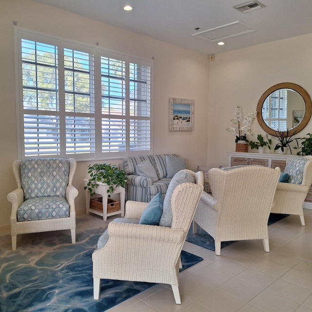 living area with light tile patterned floors, visible vents, and recessed lighting