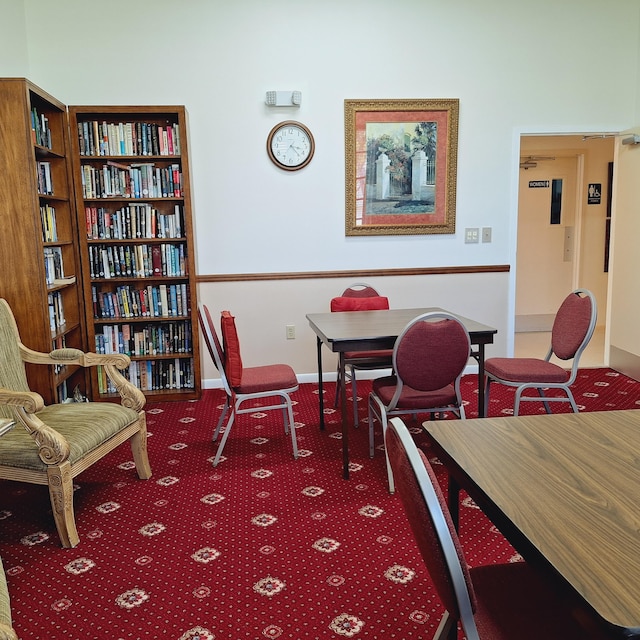 dining space with carpet and baseboards
