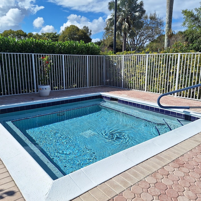 view of swimming pool featuring fence and a pool