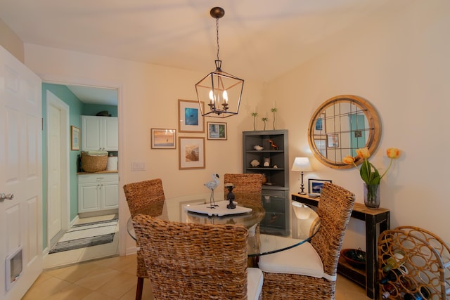 dining area with a chandelier and light tile patterned flooring