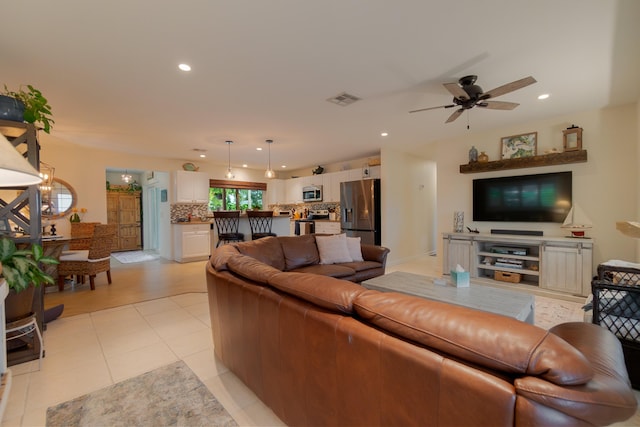 living room featuring light tile patterned flooring, visible vents, and recessed lighting