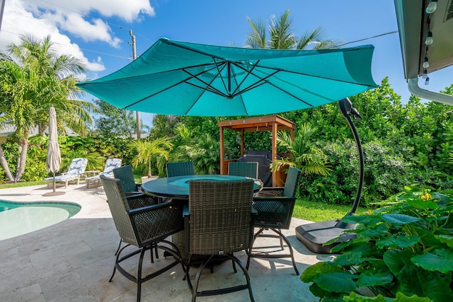 view of patio / terrace featuring outdoor dining area and an outdoor pool