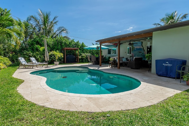 outdoor pool featuring a yard, a patio, and a ceiling fan