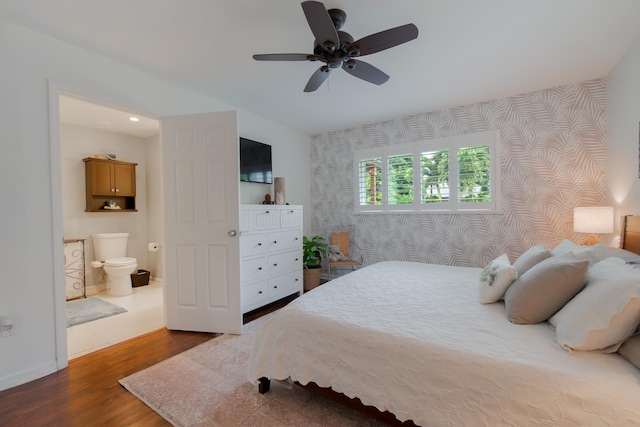 bedroom with wallpapered walls, a ceiling fan, baseboards, and wood finished floors