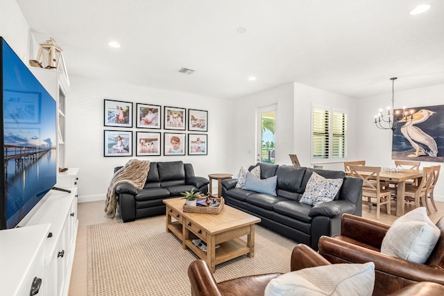 living room featuring baseboards, recessed lighting, visible vents, and an inviting chandelier