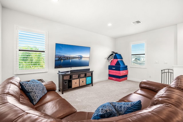 carpeted living area featuring recessed lighting, visible vents, and baseboards