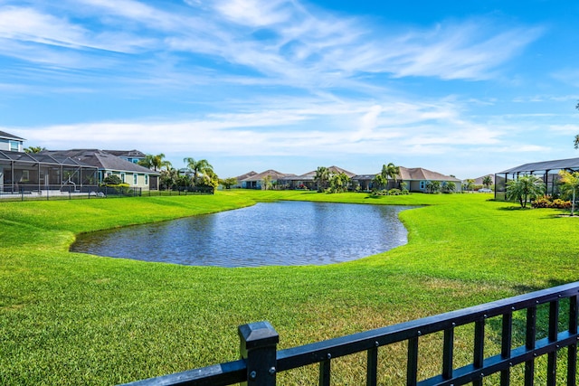 property view of water with fence and a residential view