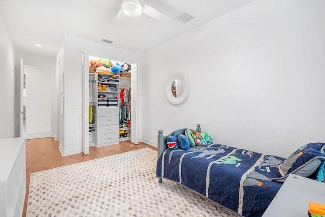 bedroom with visible vents, ceiling fan, light wood-style flooring, and baseboards