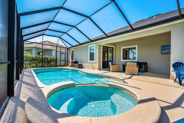 view of swimming pool featuring a patio, a lanai, and a pool with connected hot tub