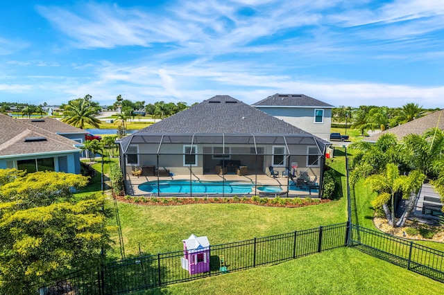 rear view of property with glass enclosure, a fenced backyard, a lawn, and a patio