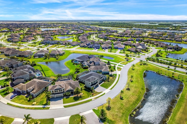 drone / aerial view with a water view and a residential view