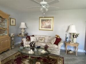 living room featuring ceiling fan and baseboards