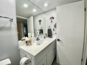 half bath featuring toilet and vanity