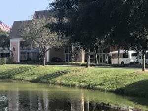 view of property's community featuring a water view and a yard