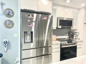 kitchen featuring white cabinetry, appliances with stainless steel finishes, light countertops, and recessed lighting