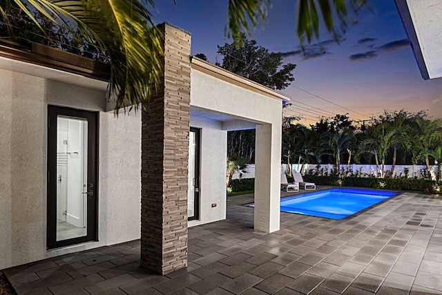 view of swimming pool featuring a patio, fence, and a fenced in pool